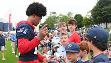 Jul 24, 2024; Foxborough, MA, USA;  New England Patriots safety Marte Mapu (15)  signs an autograph for a fan during training camp at Gillette Stadium. Mandatory Credit: Eric Canha-USA TODAY Sports