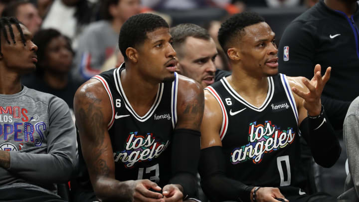 Mar 11, 2023; Los Angeles, California, USA; Los Angeles Clippers forward Paul George (13) and guard Russell Westbrook (0) watch the game against the New York Knicks from the bench at Crypto.com Arena. 