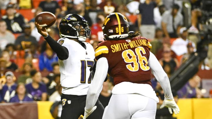 Aug 21, 2023; Landover, Maryland, USA; Baltimore Ravens quarterback Josh Johnson (17) passes as Washington Commanders defensive end James Smith-Williams (96) pursues.