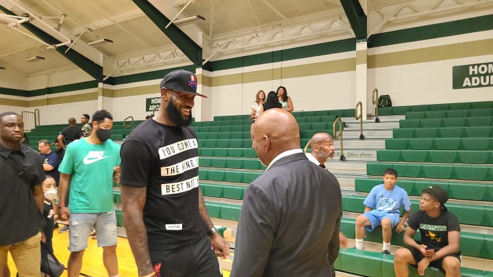 LeBron James shares a laugh with St. Vincent-St. Mary boys basketball coach Dru Joyce in July, 2022 at a ceremony naming the STVM basketball court after Joyce. LeBron James will become the first men's basketball player to carry the United States flag at an Olympic opening ceremony on July 26, 2024 in Paris. 