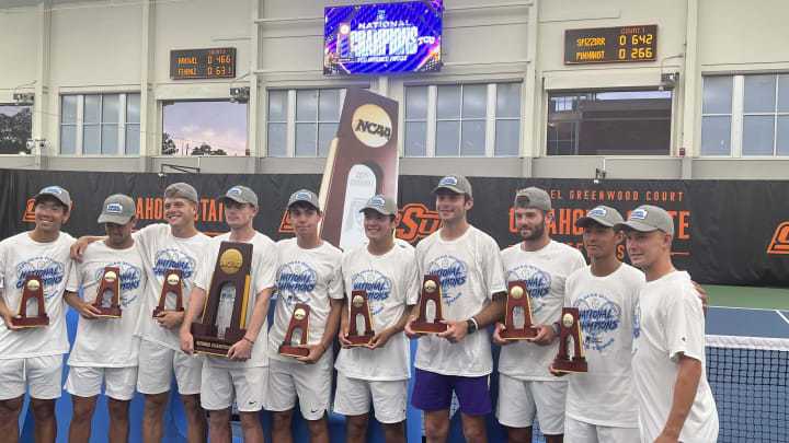 The TCU men's tennis team hoists the national championship trophy after defeating Texas 4-3. 