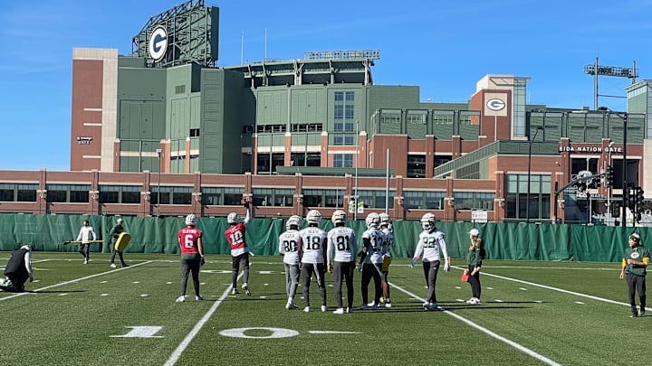 The Green Bay Packers practice with their white helmets on Wednesday.