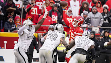 Dec 25, 2023; Kansas City, Missouri, USA; Kansas City Chiefs quarterback Patrick Mahomes (15) throws a pass as he   s pressured by Las Vegas Raiders defensive tackle Bilal Nichols (91) and defensive end Maxx Crosby (98) and defensive end Janarius Robinson (97) during the game at GEHA Field at Arrowhead Stadium. Mandatory Credit: Denny Medley-Imagn Images