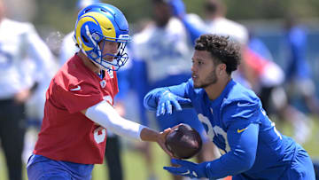 May 28, 2024; Thousand Oaks, CA, USA;  Los Angeles Rams quarterback Matthew Stafford (9) hands off to running back Blake Corum (22) during OTAs at California Lutheran University. Mandatory Credit: Jayne Kamin-Oncea-Imagn Images