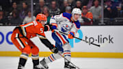 Apr 7, 2025; Anaheim, California, USA; Edmonton Oilers center Ryan Nugent-Hopkins (93) shoots against Anaheim Ducks defenseman Olen Zellweger (51) during the first period at Honda Center. Mandatory Credit: Gary A. Vasquez-Imagn Images