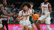 Nov 3, 2025; Coral Gables, Florida, USA; Miami Hurricanes guard Tre Donaldson (3) drives to the basket against the Jacksonville Dolphins during the second half at Watsco Center. Mandatory Credit: Sam Navarro-Imagn Images
