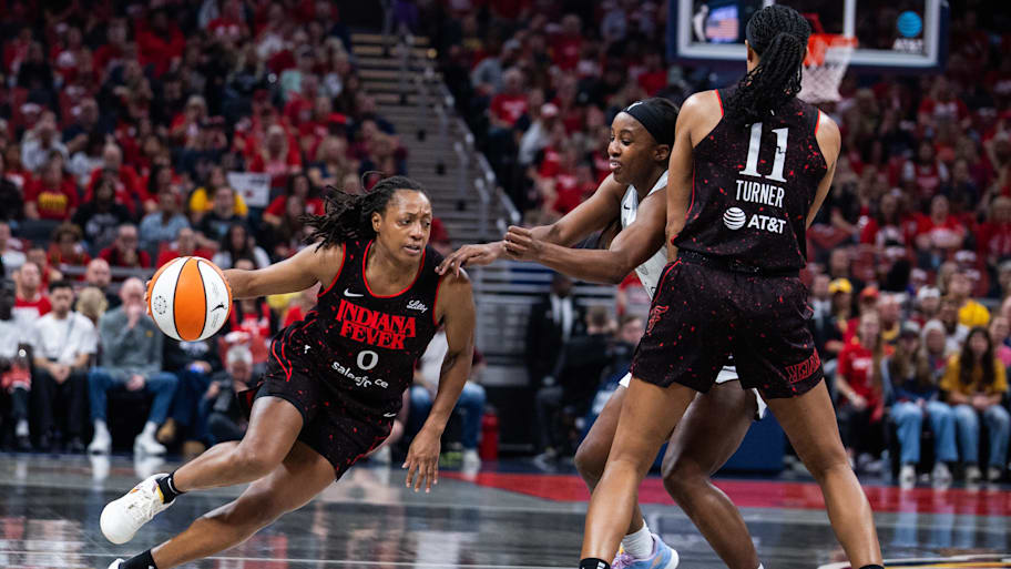  Fever guard Kelsey Mitchell (0) dribbles the ball while Las Vegas Aces guard Jackie Young