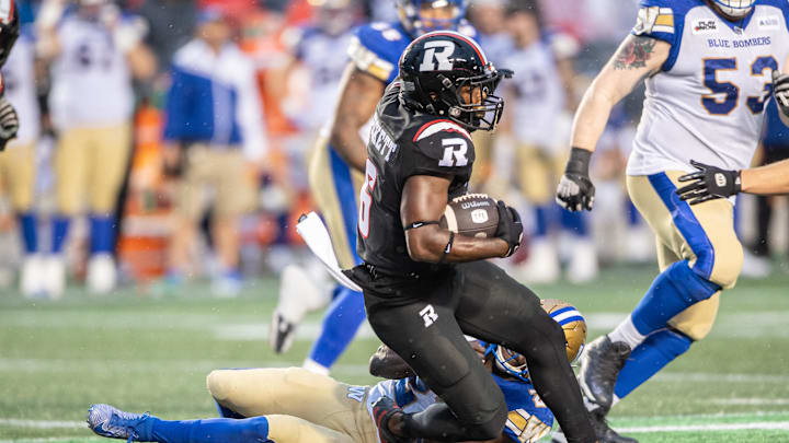 Jun 13, 2024; Ottawa, Ontario, CAN; Ottawa REDBLACKS defenseive back Adarius Pickett (6) is tackled by Winnipeg Blue Bombers running back Johnny Augustine (27) in the first half at TD Place. Mandatory Credit: Marc DesRosiers-Imagn Images