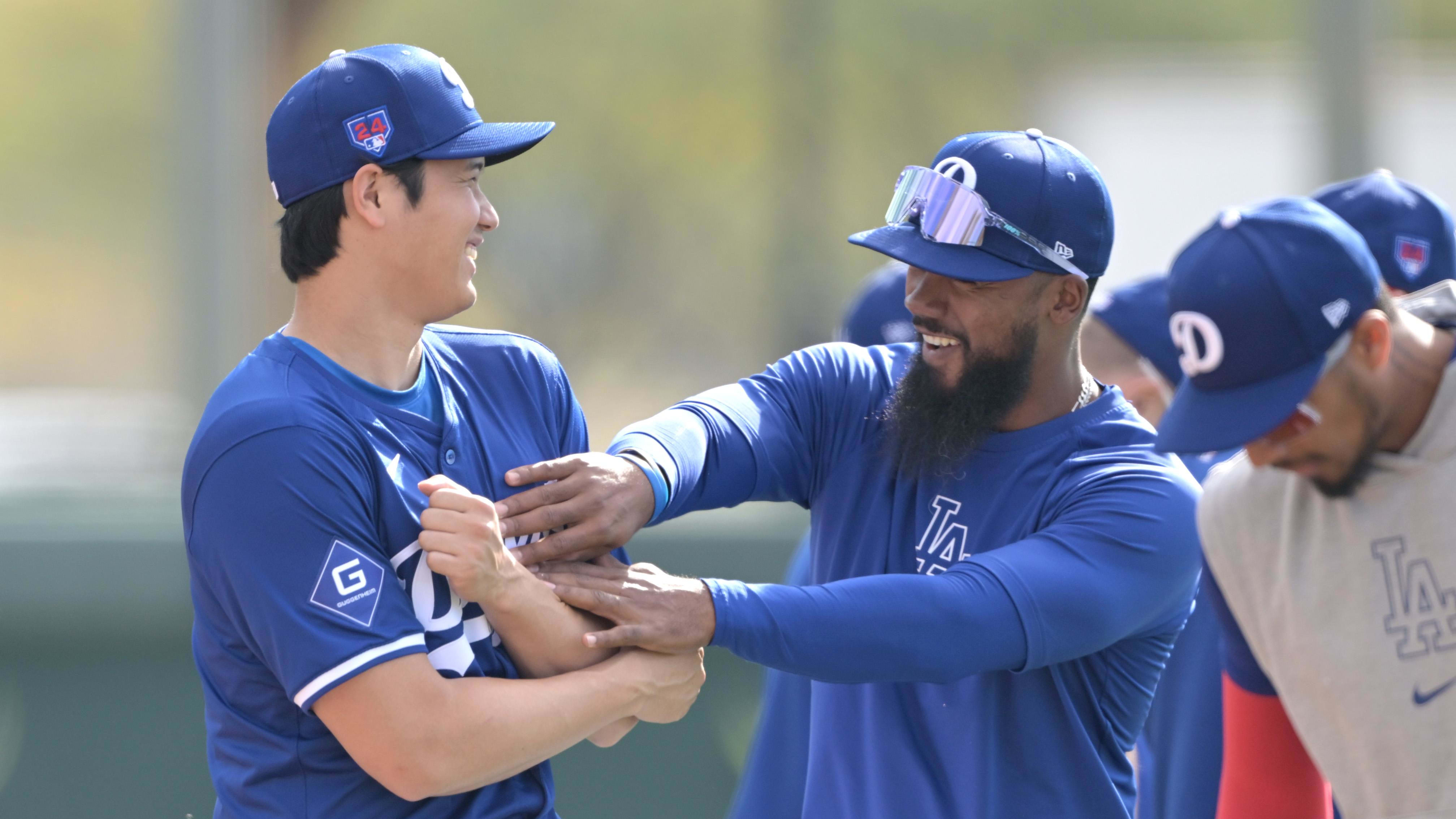 Feb 18, 2024; Glendale, AZ, USA;  Shohei Ohtani and Teoscar Hernandez laugh together during Dodgers spring training.