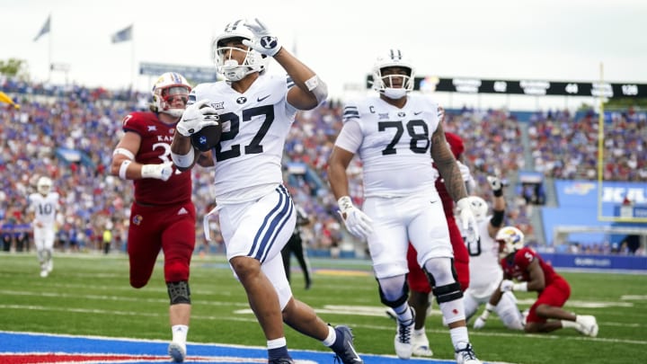 Sep 23, 2023; Lawrence, Kansas, USA; Brigham Young Cougars running back LJ Martin (27) scores a touchdown against the Kansas Jayhawks during the first half at David Booth Kansas Memorial Stadium.