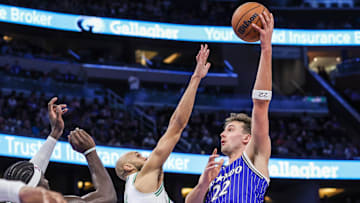 Nov 9, 2025; Orlando, Florida, USA; Orlando Magic forward Franz Wagner (22) shoots against Boston Celtics guard Derrick White (9) during the second half at Kia Center. Mandatory Credit: Mike Watters-Imagn Images