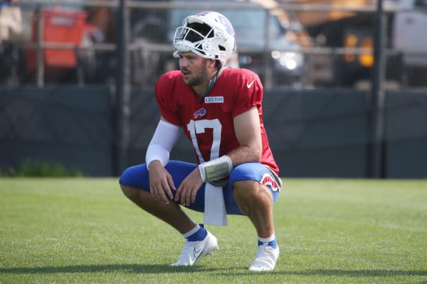 Josh Allen resting at a Bills practice.