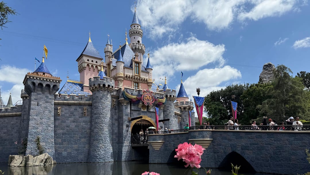 Sleeping Beauty Castle is adorned with Disneyland 70th anniversary flourishes.