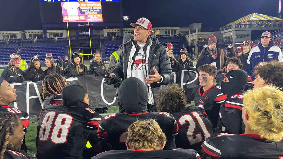 Quince Orchard head football coach John Kelley addresses his team after its victory in the 2024 MPSSAA 4A state championship game.