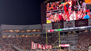 FSU's cheerleaders and football team sprint onto the field at Doak Campbell Stadium for Saturday's showdown against Miami.