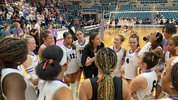 Fulshear coach Sydney Zimmerman discusses strategy with her team during a timeout in their regional final victory over Cinco Ranch, on Friday.