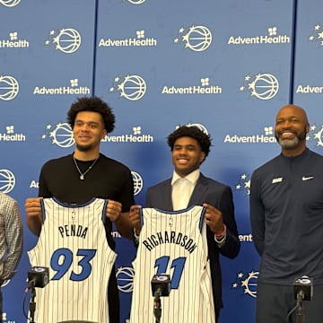 Orlando Magic draft picks Jase Richardson and Noah Penda pose with their jerseys at introductory press conference. 