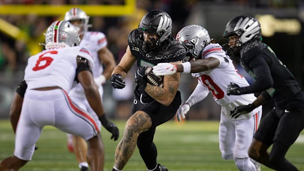 Oregon’s Terrance Ferguson runs for a first down vs. Ohio State.