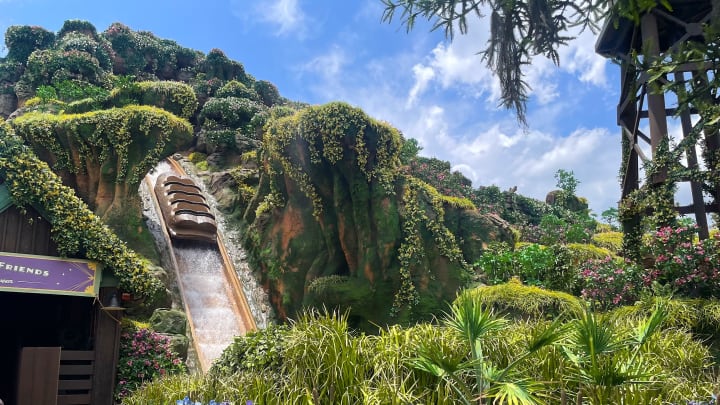 A boat goes down the drop at Tiana's Bayou Adventure