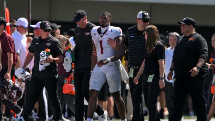 Aug 31, 2024; Nashville, Tennessee, USA;  Virginia Tech Hokies quarterback Kyron Drones (1) gets helped off the field against the Vanderbilt Commodores during the second half at FirstBank Stadium. Mandatory Credit: Steve Roberts-USA TODAY Sports