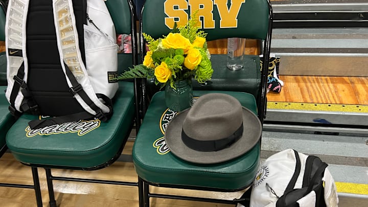 A memorial for San Ramon Valley assistant basketball coach Hans de Lannoy — his signature hat and roses — was left on the Wolves' No. 1 chair during the Wolves' 71-60 win over cross-town rival Monte Vista on Friday. De Lannoy, a beloved 40-year coach and teacher, died Wednesday due to complications from cancer. 