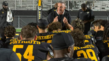 American Heritage coach Mike Smith addresses his club after a comfortable 51-12 win against Western.