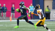 Dec 31, 2023; Seattle, Washington, USA; Seattle Seahawks wide receiver DK Metcalf (14) carries the ball after a catch against the Pittsburgh Steelers during the second half at Lumen Field. Mandatory Credit: Steven Bisig-USA TODAY Sports