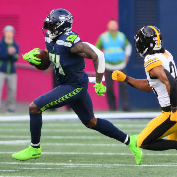 Dec 31, 2023; Seattle, Washington, USA; Seattle Seahawks wide receiver DK Metcalf (14) carries the ball after a catch against the Pittsburgh Steelers during the second half at Lumen Field. Mandatory Credit: Steven Bisig-USA TODAY Sports