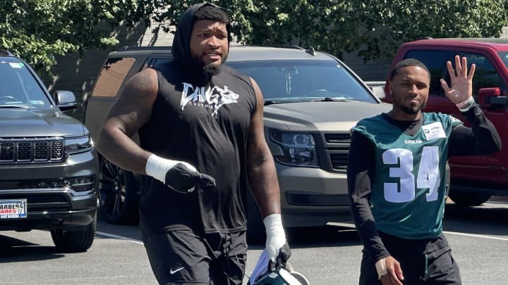 Eagles OT Fred Johnson arrives at practice with teammate Isaiah Rodgers on Aug. 28, 2024.