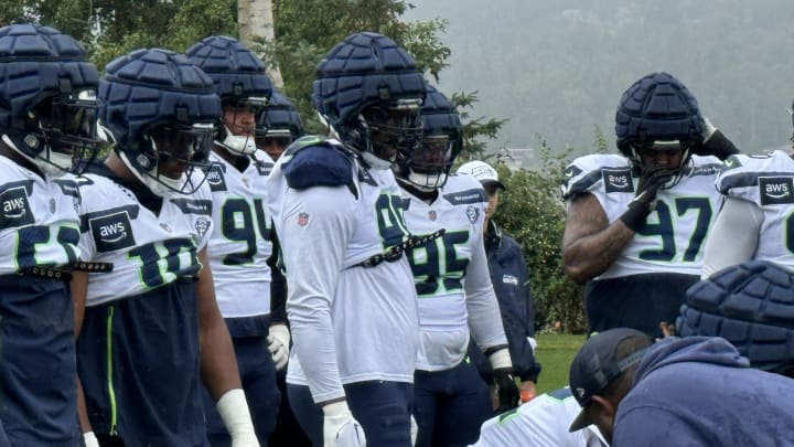 Seattle Seahawks defensive tackle Leonard Williams (99) and linebacker Uchenna Nwosu (10) listen during a training camp drill.