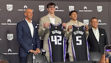 Maxime Raynaud and Nique Cliffard hold up their Sacramento Kings jerseys at their introductory press conference