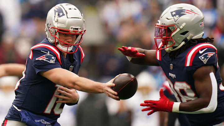  New England Patriots quarterback Drake Maye (10) hands off the ball to running back Rhamondre Stevenson (38) against the Los Angeles Chargers in the first quarter at Gillette Stadium.