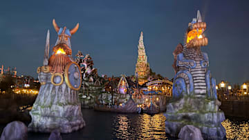 Fires glow in Universal Epic Universe's How to Train Your Dragon – Isle of Berk at night.