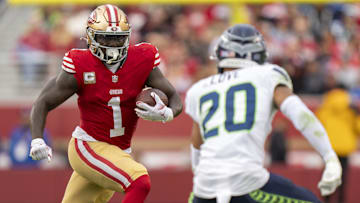 November 17, 2024; Santa Clara, California, USA; San Francisco 49ers wide receiver Deebo Samuel Sr. (1) runs the football against Seattle Seahawks safety Julian Love (20) during the fourth quarter at Levi's Stadium. Mandatory Credit: Kyle Terada-Imagn Images