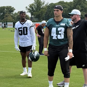Eagles, from left to right, Josh Uche, Ogbo Okoronkwo, and Ben VanSumeren leave the field after Day 10 of training camp.