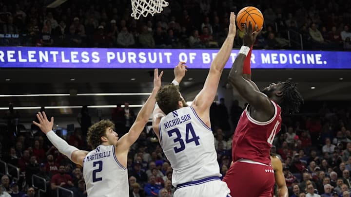Jan 22, 2025; Evanston, Illinois, USA; Northwestern Wildcats center Matthew Nicholson (34) defends Indiana Hoosiers center Oumar Ballo (11) during the first half at Welsh-Ryan Arena. Mandatory Credit: David Banks-Imagn Images