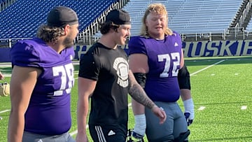 Jake Flores, Zach Durfee and John Mills head to the locker room after UW spring practice. 