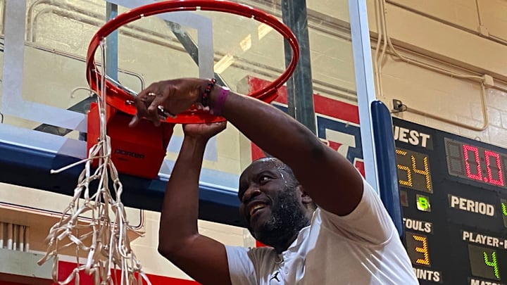 St. Thomas Aquinas basketball coach Julius Sandi cuts down the nets after the Raiders won the 51st annual Kingdom of the Sun tournament at Ocala Vanguard on Monday. St. Thomas Aquinas basketball coach Julius Sandi cuts down the nets after the Raiders won the 51st annual Kingdom of the Sun tournament at Ocala Vanguard on Monday.
