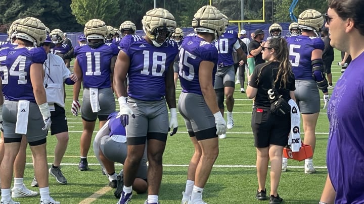 Jayden Wayne prepares to stretch with his UW teammates.