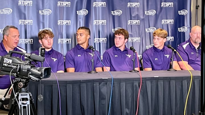 Coach Tom Tri, left, answers a question as his Lake Stevens players listen during 4A Wesco media day Sunday at Angel of the Winds Arena in Everett.