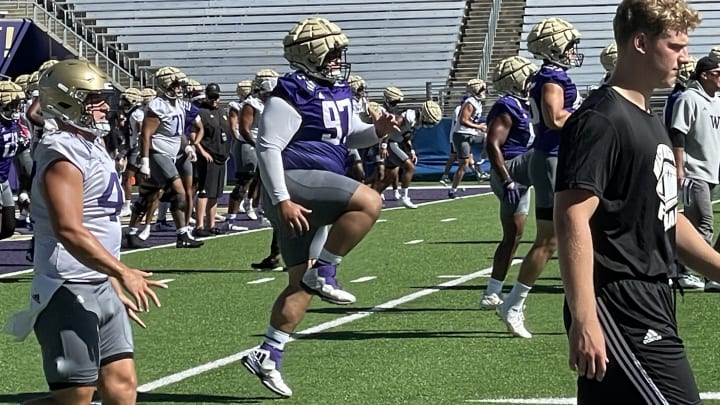 Logan Sagapolu, the Miami transfer, runs through UW stratching.