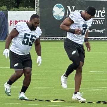 Brandon Graham (left) and Nolan Smith go through a ladder drill prior to one of the Eagkes' training camp practices.