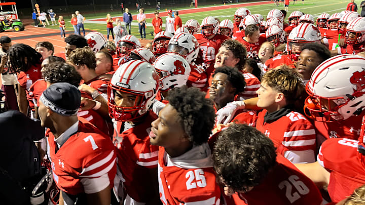 Archbishop Spalding football players sing its The Cavaliers moved to 4-0 with a 45-0 win over McDonogh School Friday evening.