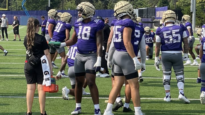 Jayden Wayne (18) gets a water break at UW practice.