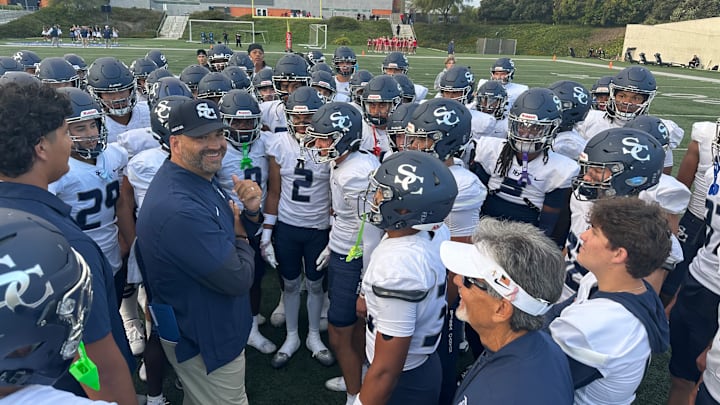 Sierra Canyon football coach Jon Ellinghouse smiles before addressing his team before taking on Orange Lutheran on Sept. 18, 2025 at Orange Coast College.