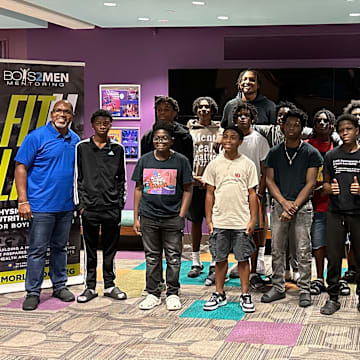 Orlando Magic center Wendell Carter Jr. (back middle) meets with students from Orlando-based mentorship program Boys 2 Men.