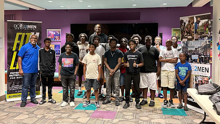 Orlando Magic center Wendell Carter Jr. (back middle) meets with students from Orlando-based mentorship program Boys 2 Men.