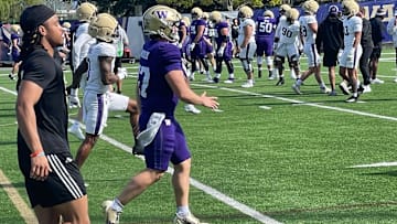 Cameron Warchuck is shown in warm-ups at his last UW football practice, just ahead of injured receiver Omari Evans.