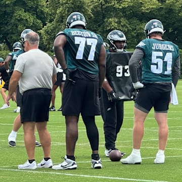 Philadelphia Eagles interior linemen prepare for a drill under O-line coach Jeff Stoutland (left). From left to right: Mekhi Becton, Cam Jurgens, and Tyler Steen.