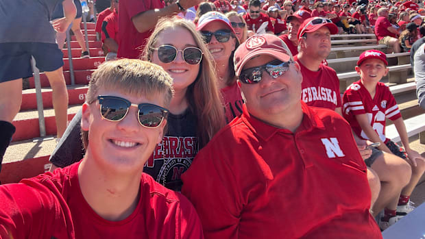 Scott Cyboron (right) alongside his son, daughter, and wife at Lincoln's Memorial Stadium. 